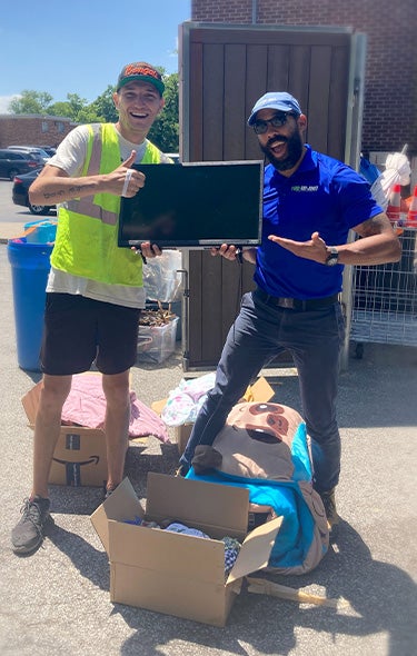 1-800-GOT-JUNK? Cincinnati team member donating old TV at donation drop-off center