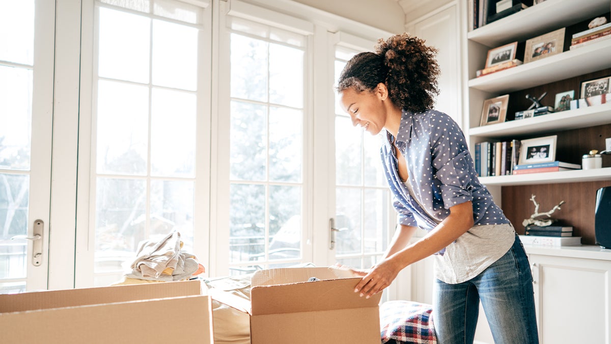 Woman packing up unwanted items for disposal