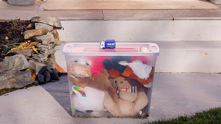 Mini 1-800-GOT-JUNK? truck on a clear bin with stuffed animals