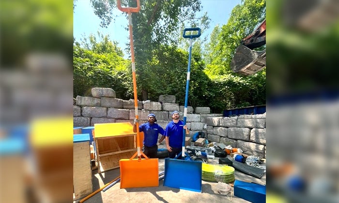 Two 1-800-GOT-JUNK? Truck Team Members with 20ft shovels.